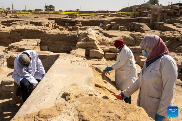 taff members work at the Montu Temple precinct in the Karnak Temple Complex