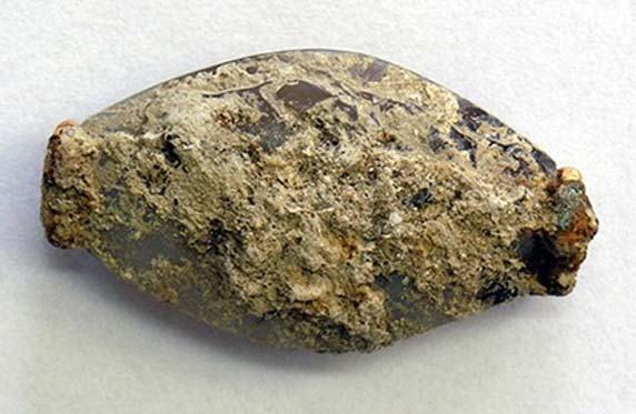 The limestone-encrusted sealstone was discovered lying face-down near the right arm of the Griffin Warrior. 