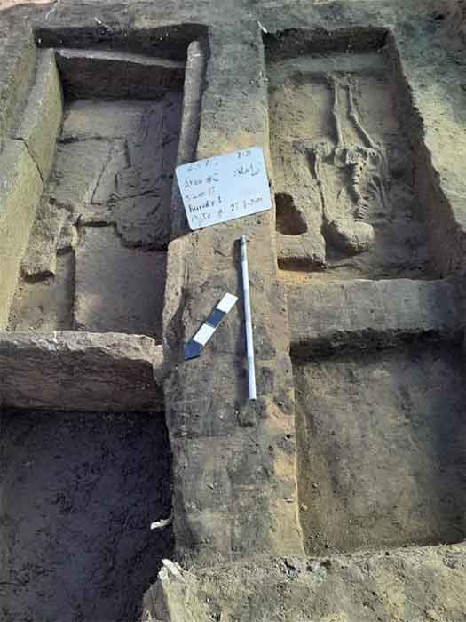 The remains of two people in mudbrick burials from an earlier period, which were found beneath the pottery workshop site. (Ministry of Tourism and Antiquities)