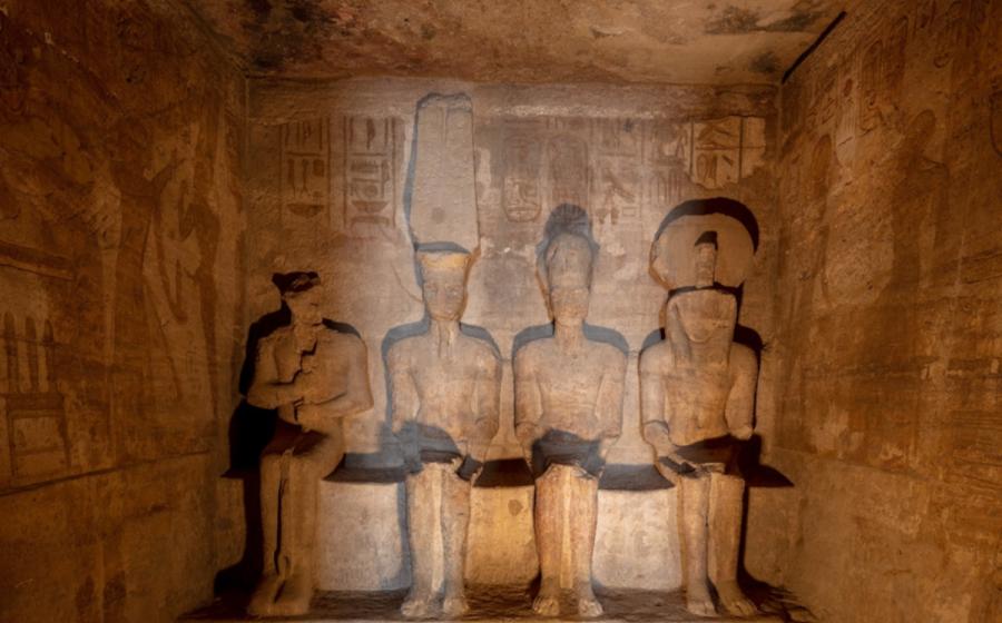 Sunlit statues in the inner sanctuary of the Great Temple at Abu Simbel.