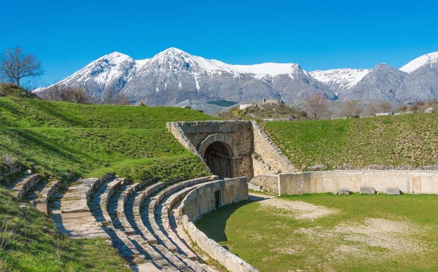 Alba Fucens, Roman archaeological site with amphitheater. Monte Velino mountain with snow, Abruzzo region, central Italy   Source: ValerioMei / Adobe Stock