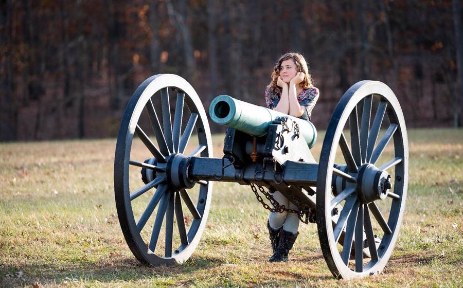 Young happy woman standing by an American Civil War canon in Manassas National Battlefield Park, Virginia. 		Source: Andriy Blokhin / Adobe Stock