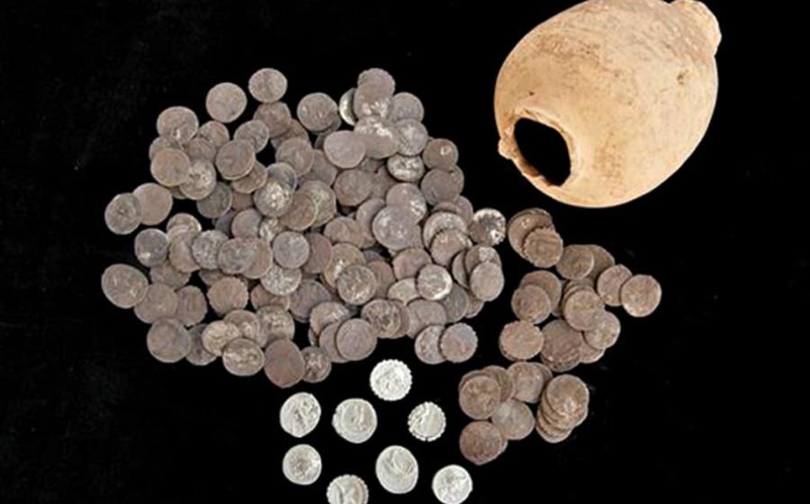 The Roman silver coins that were recently discovered in Ampurias, Spain and the amphora in which they were held. 