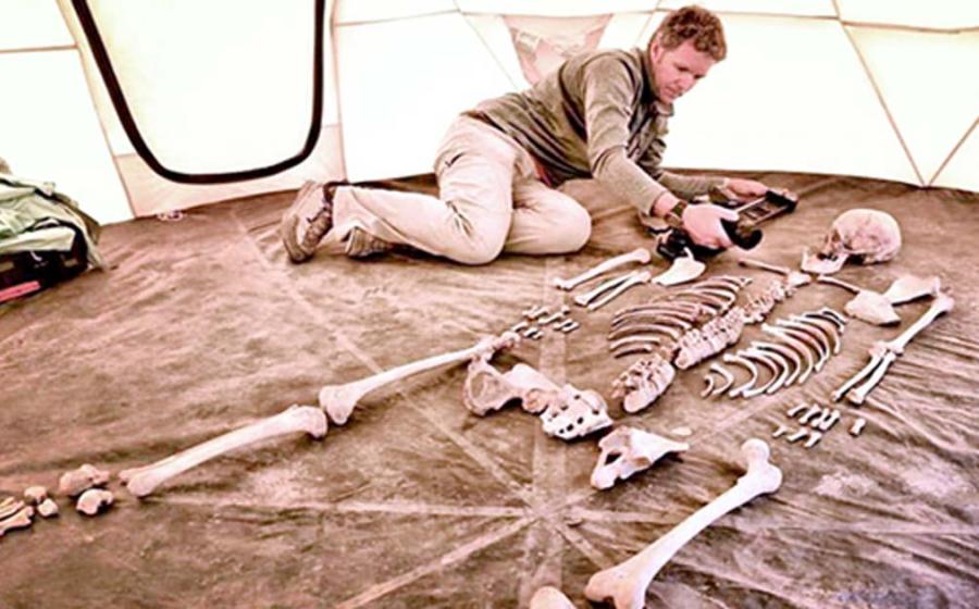 Researcher and filmmaker Jake Norton photographs a 1,200-year-old skeleton from Samdzong, Nepal. 