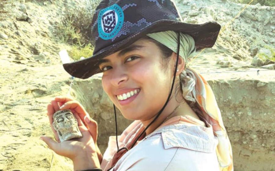 Researcher holding the faience mask found in Bahrain
