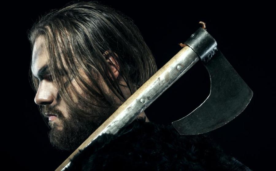 Medieval battle reenactor defended his home using an ancient battle ax. Source: alexmina / Adobe Stock.