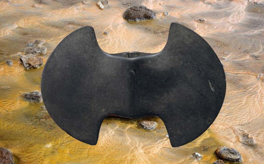 A bannerstone, the Metropolitan Museum of Art. (CC0) Background: Rocks and water. (CC0)