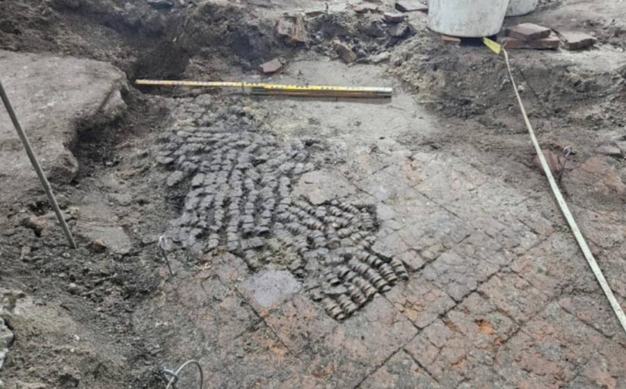 Tile floor patched with cow bones, found during excavations in Alkmaar city center.