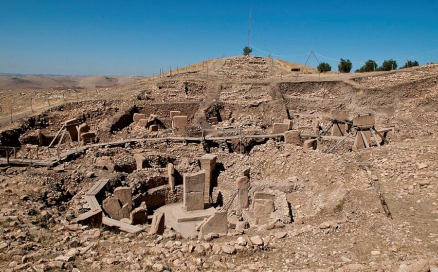 Göbekli Tepe's excavated stone enclosures and surrounding hill in southeastern Turkey.   