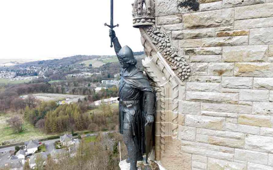 William Wallace statue stands proudly. The National Wallace Monument is a tower standing on a hilltop in Stirling in Scotland. Source: Jacek/Adobe Stock