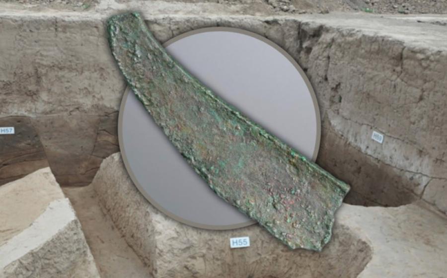 A broken bronze dagger-axe from the Jiangliu burial site, Shaanxi Province, with background of the excavation.