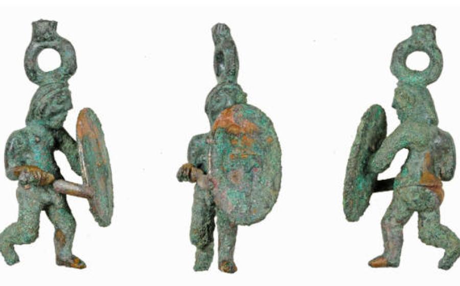 The Celtic warrior statuette after restoration, depicting a warrior in lunging pose with sword and shield