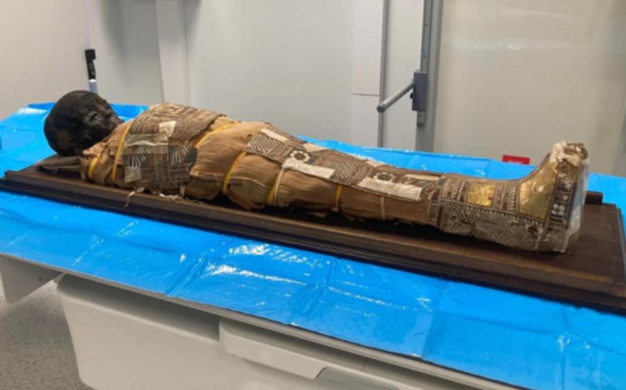The 2,000-year-old Egyptian child mummy resting on a table before examination. 