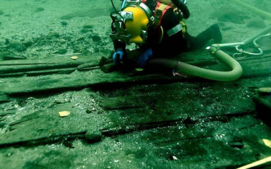 Medieval cog shipwreck underwater excavation showing divers at work on Svælget 2 