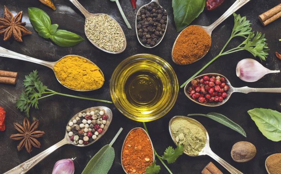 Culinary and medicinal spices and herbs on a wooden board
