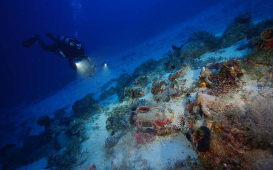 An archaeologist systematic photographs a wreck site to create a 3D site plan by Vasilis Mentogiani.