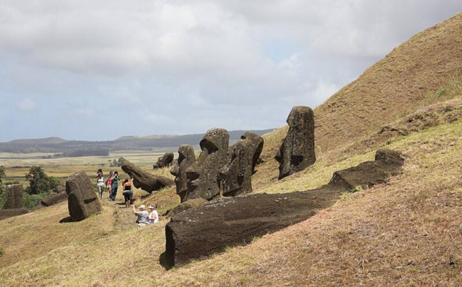 Statue heads on Easter Island in various stages of completion before they were abandoned in a crater.   