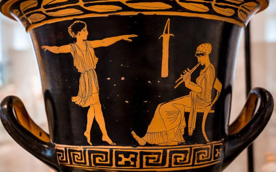 A dancing girl and woman (music teacher) seated on chair playing auloi on red and black ceramic.