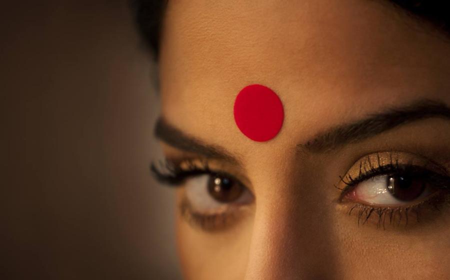 Close-up of a woman's eyes and red bindi.