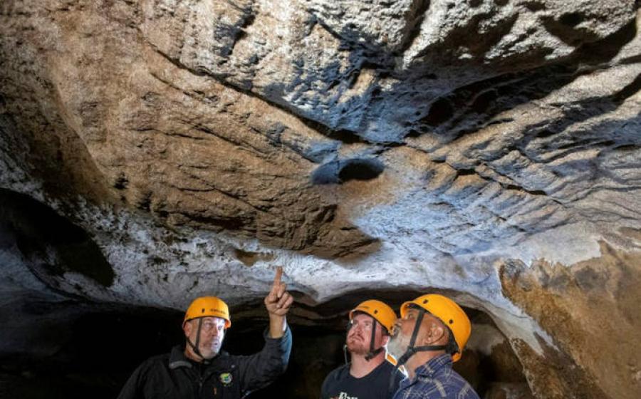 Mal and Dylan Siely examine finger grooves at Waribruk with GunaiKurnai Elder Uncle Russell Mullett