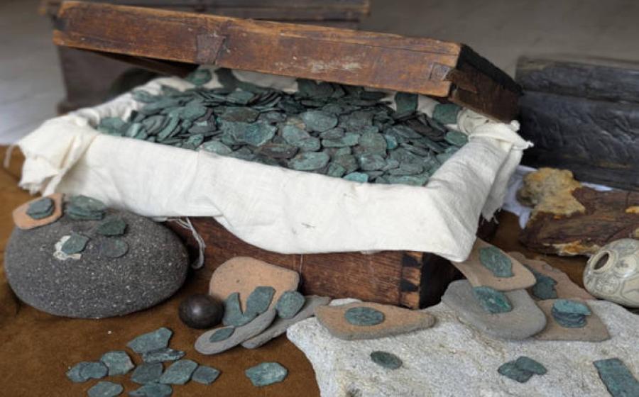 Some of the coins and treasure from the wrecksite, in a modern treasure chest.