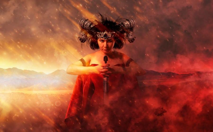 Gothic queen in red dress doing magic