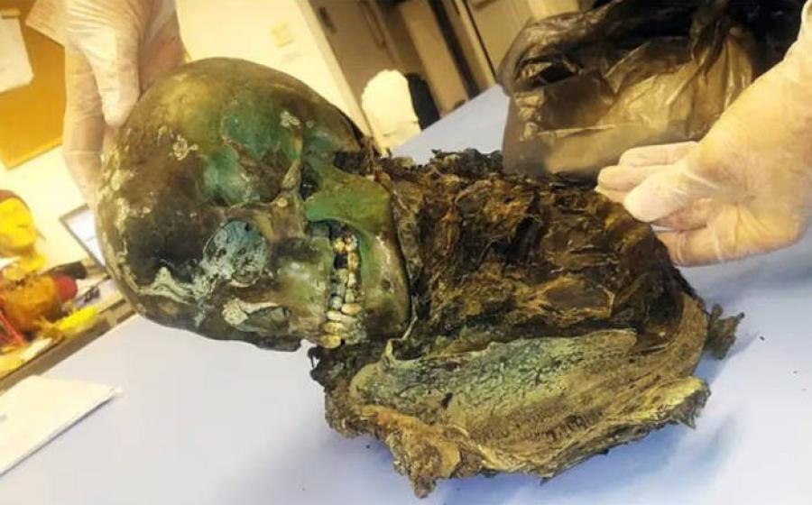 The mummified remains of the teenager, colored green.
