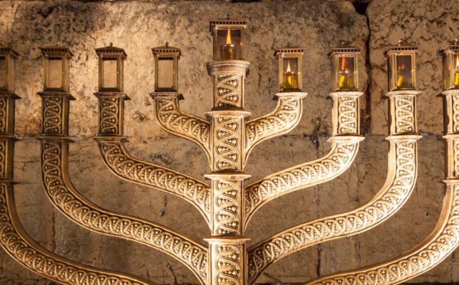 Hanukkah menorah with wailing wall in the background