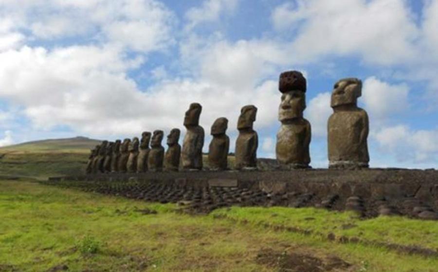 Restored statue platform with standing moai on the south coast of Rapa Nui. Note that one of the moai is adorned with a red scoria pukao. 