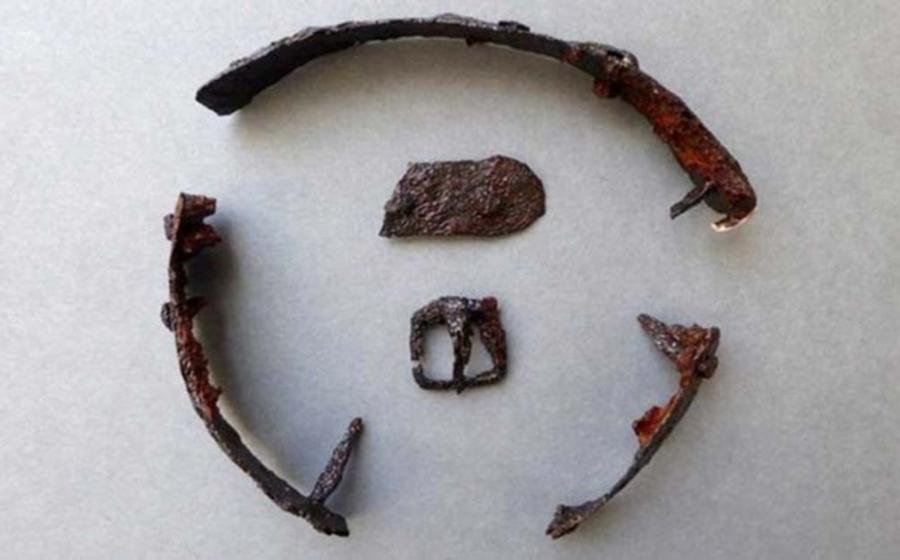 A buckle and part of a strap were found with the metal pieces. Credit: Border Archaeology