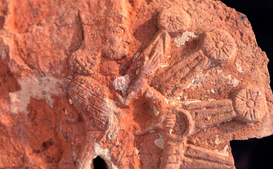 A fragment of the stone stele from the Ishtar temple. It depicts the goddess Ishtar inside a starburst with rosettes. Source: Penn Museum