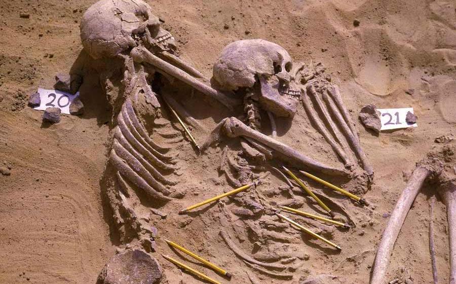 Archival photograph showing a double burial from the Jebel Sahaba cemetery in Sudan, with pencils marking the position of associated lithic artifacts. Source: Wendorf Archives of the British Museum/Scientific Reports