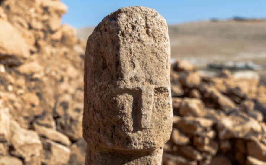A 12,000-year-old T-shaped pillar featuring a carved human face discovered at Karahantepe in southeastern Turkey.