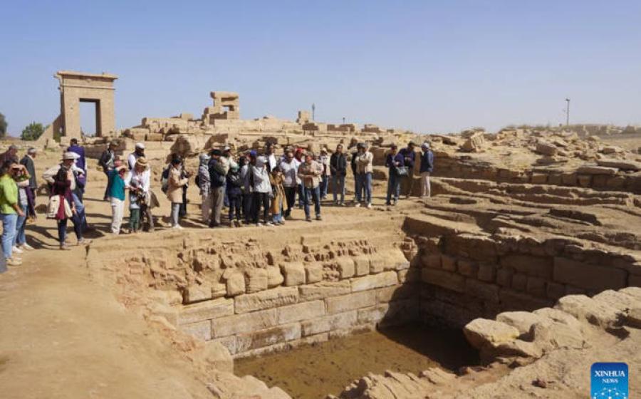 : Guests visit the ruins of the “sacred lake” at the Montu Temple precinct, Karnak, Luxor.