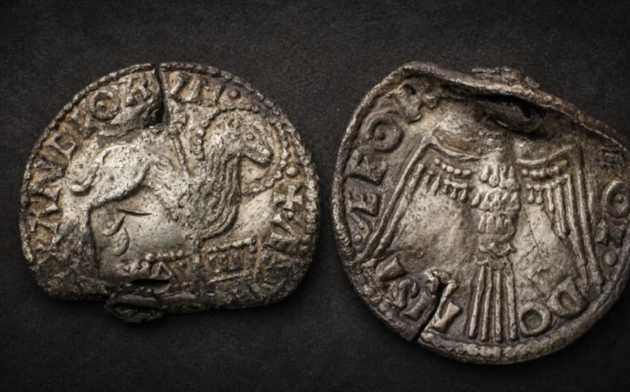 Obverse and reverse of the rare Anglo-Saxon Agnus Dei coin: the front shows the Lamb of God pierced by a cross and standing above the Alpha and Omega, while the reverse features the Holy Spirit dove.