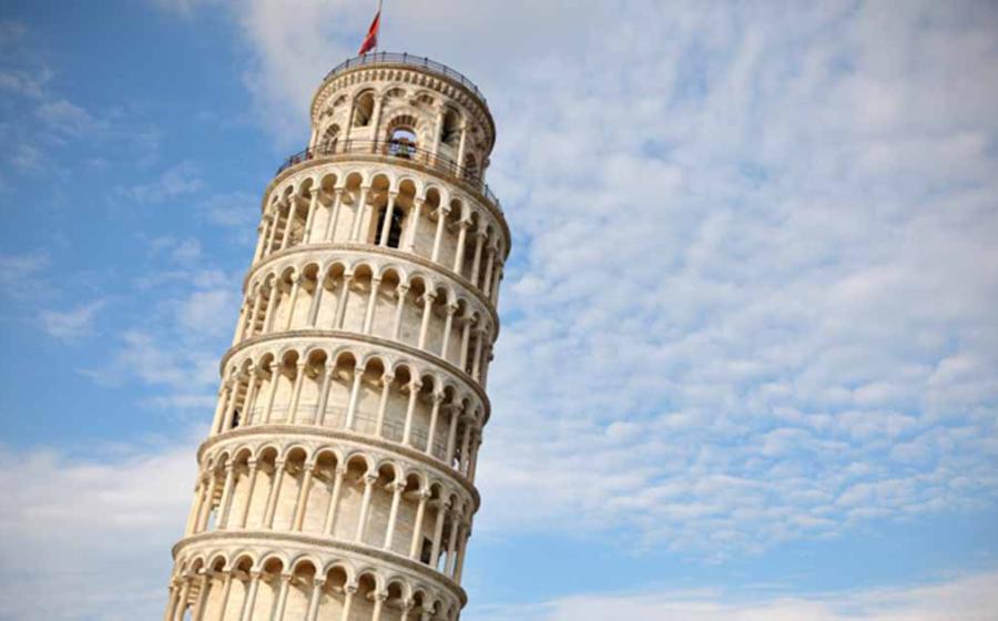 Leaning tower of Pisa at sunset, with cloudy blue skies.  Source: sugar0607/Adobe Stock