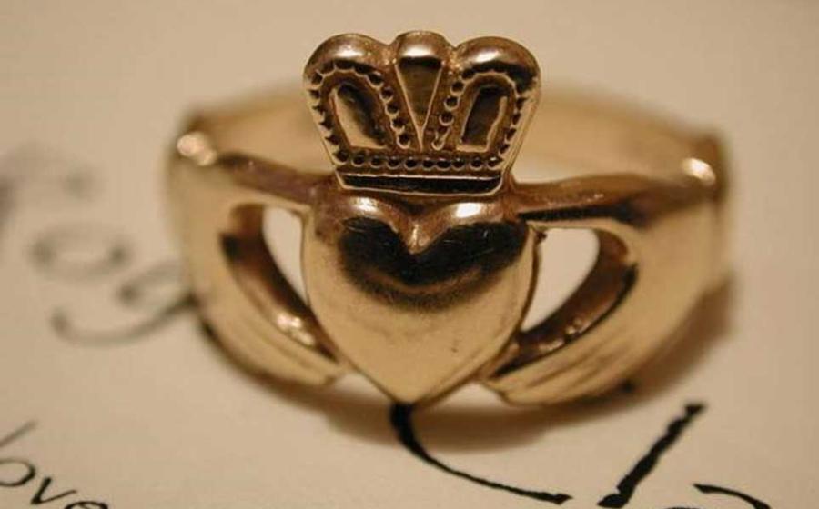 A gold Claddagh wedding ring. 