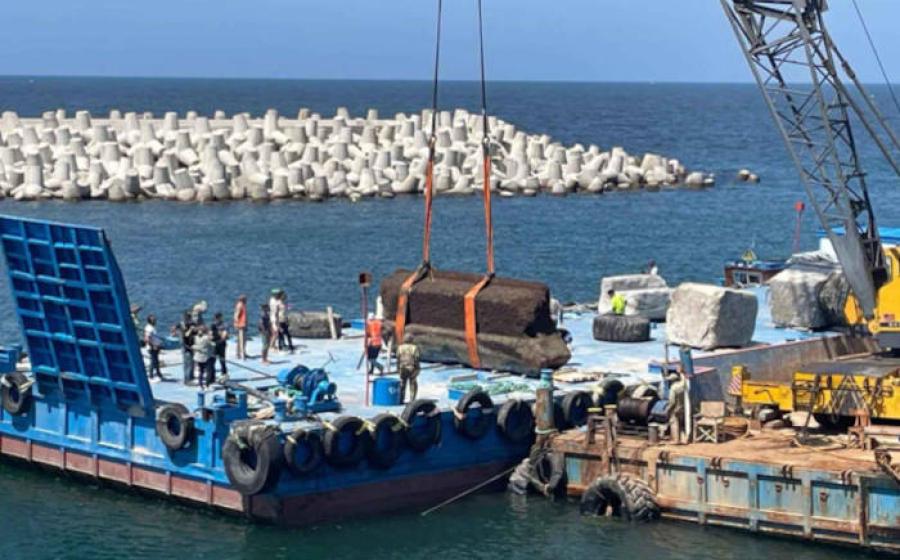Huge stone blocks from the Lighthouse of Alexandria lifted from the seabed to platforms at Alexanfria harbor.