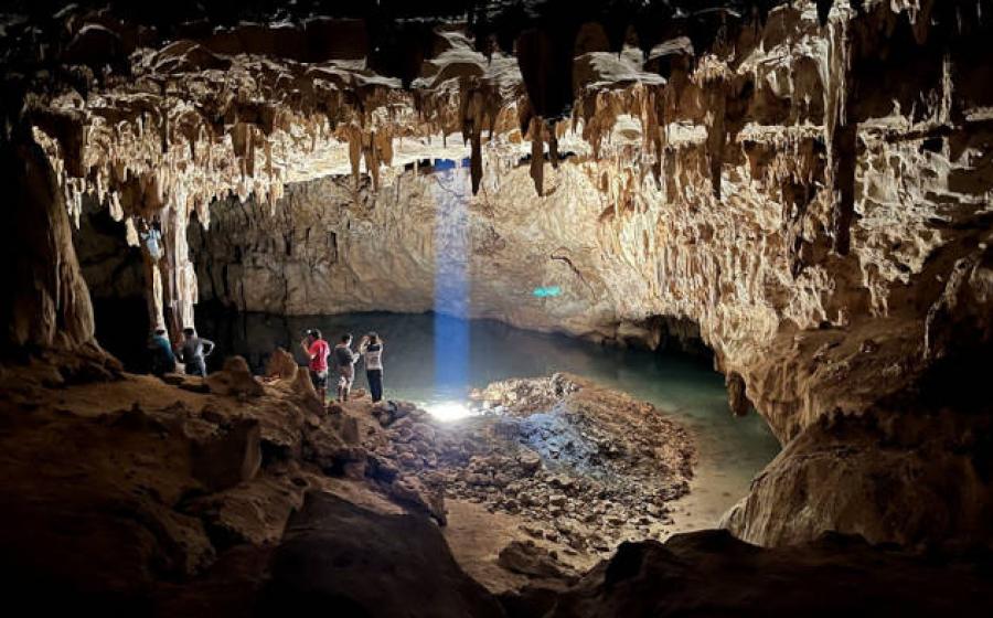 Tourists explore the 'Dome of the Cathedral', the largest chamber in Grutas Tzabnah, Yucatán, Mexico