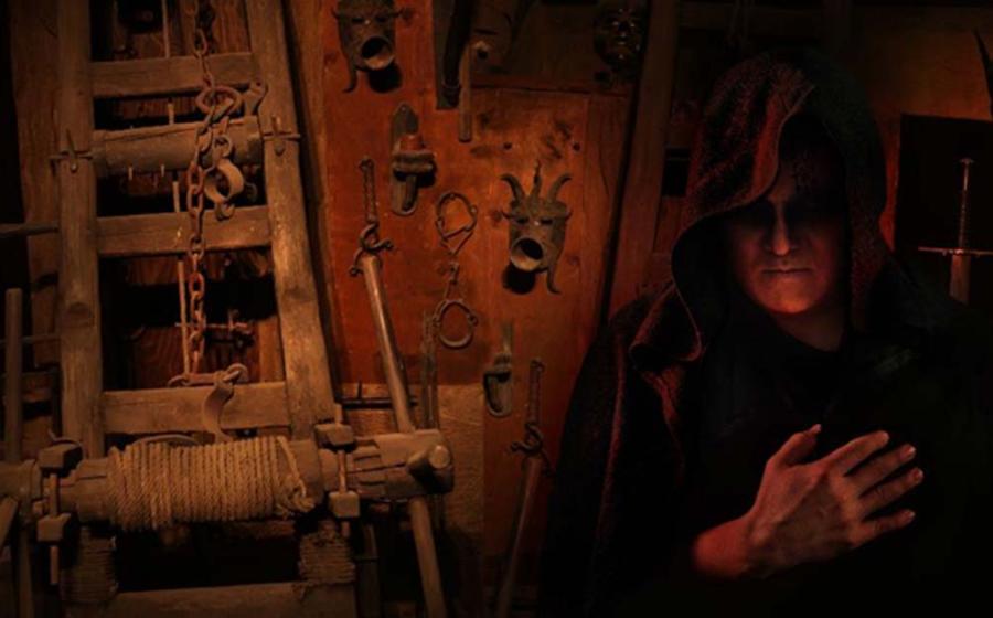 : A hooded Inquisitor in a Medieval torture chamber. Source: diter /Adobe Stock