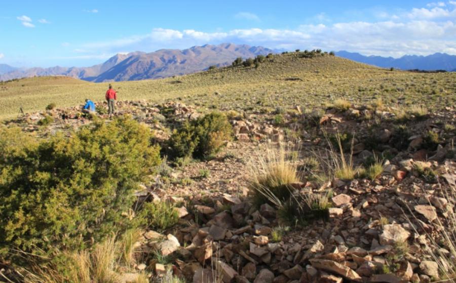 Expedition members amid the stone structures at the archaeological site in the Cordillera del Tigre, Mendoza