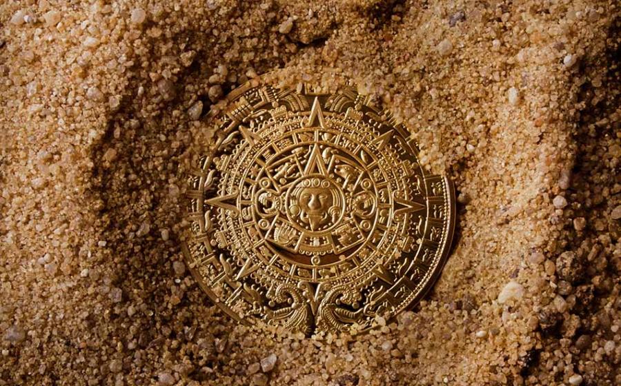 Aztec coin in sand. Source: breakermaximus / Adobe Stock.