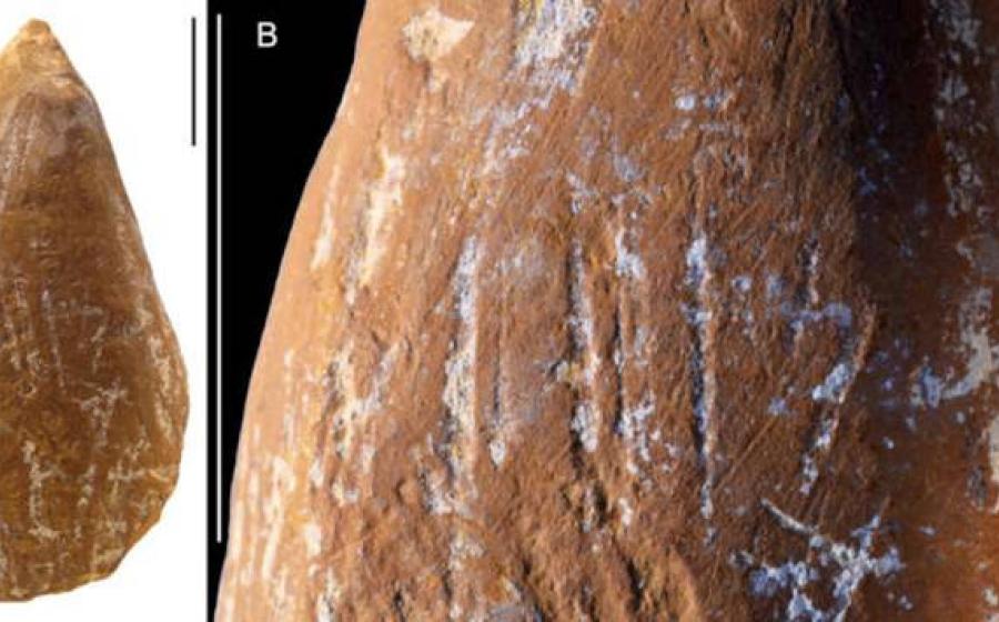 Scraped and ground ochre crayon showing deliberate modification.