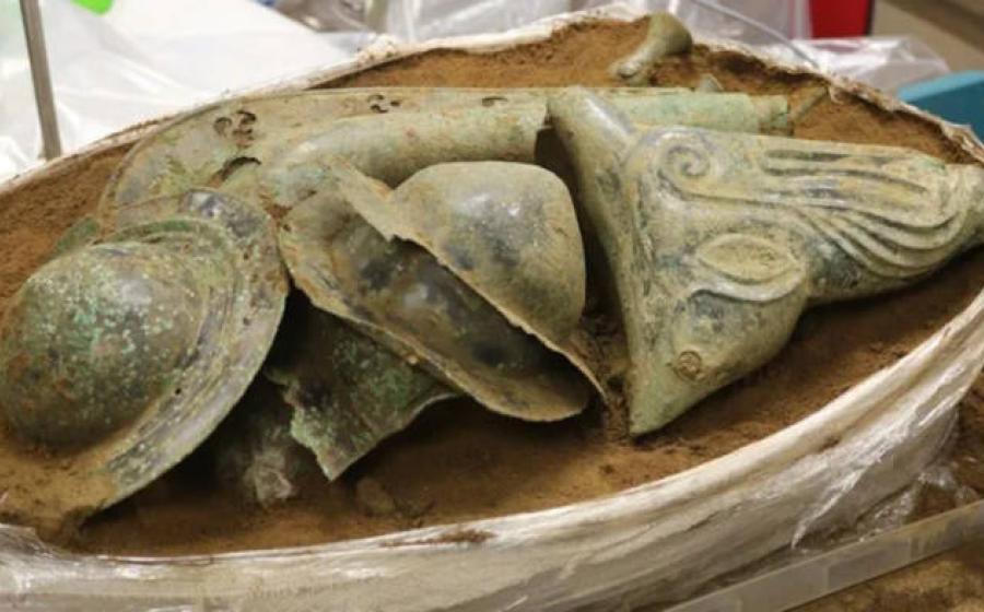 The Iron Age hoard from Norfolk, showing shield bosses in the center with the boar's head visible on the right, and the carnyx at the back
