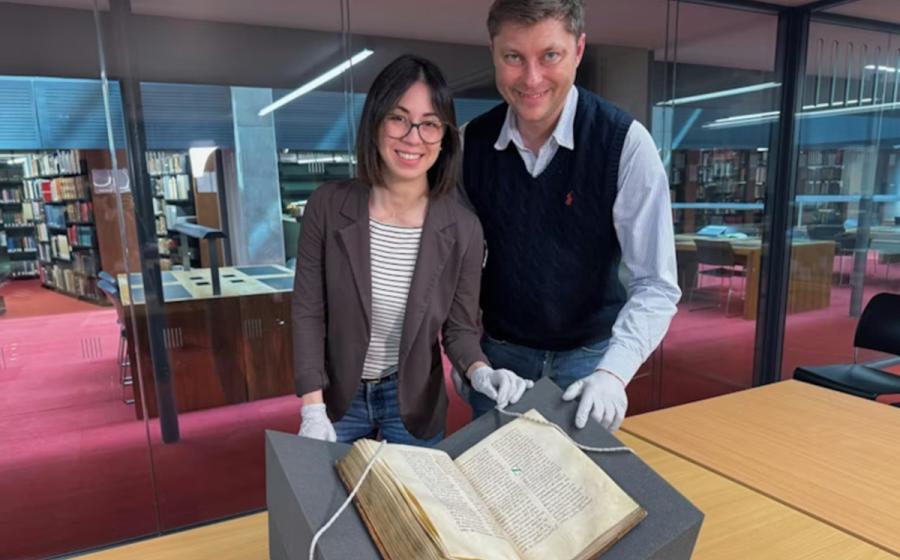 : Dr Elisabetta Magnanti and Dr Mark Faulkner with the Trinity copy of Bede’s Ecclesiastical History