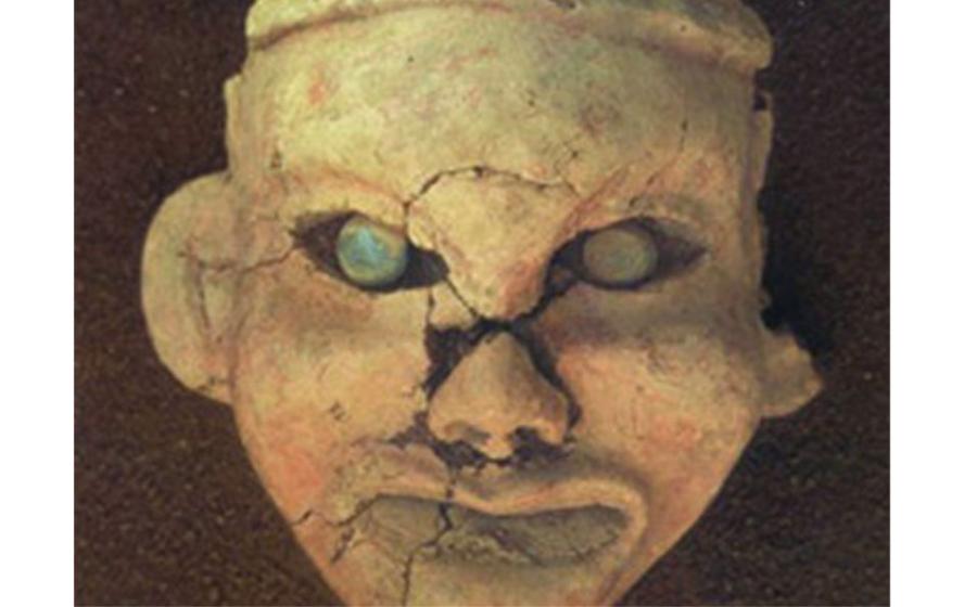 Painted clay goddess face with eyes inset with jade, found at Goddess Temple, Niuheliang.