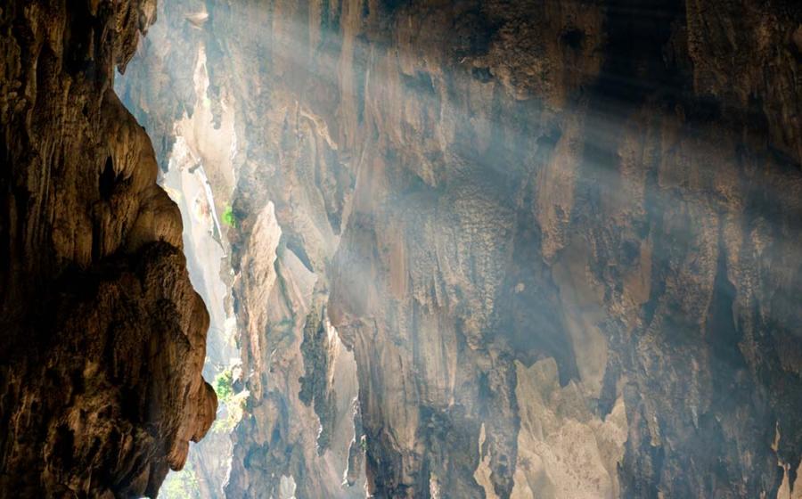 Ray of sunlight entering a rock chamber, representational. Source: Lina / Adobe Stock.
