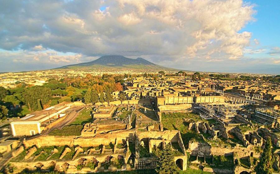 Ruins of Pompeii seen from the above with a drone, with the Vesuvius in the background 