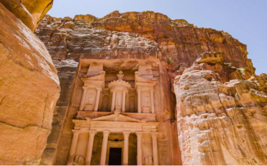 Carved stone façade of rock hewn Treasury building at Petra. 
