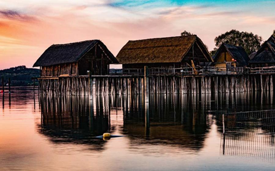 Colorful sunset at Lake Dwellings of the Stone and Bronze Age at Pfahlbaumuseum in Unteruhldingen on Lake Constance, Baden-Wurttemberg.